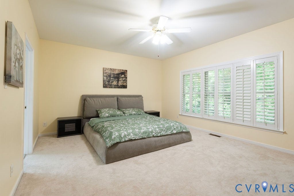 14107 Beachmere Road, Stoney Glen South, Chester, VA 23831 Spacious room with plush carpeting, a wide window featuring plantation shutters, a ceiling fan, and vaulted ceilings