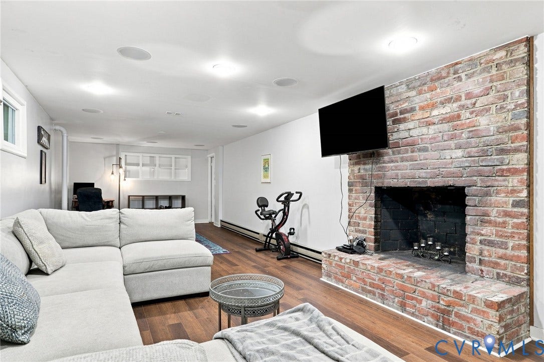 1427 Spring Grove Drive, Richmond, VA 23225 Brick fireplace with a hearth, wood-finish flooring, recessed lighting, and built-in ceiling speakers