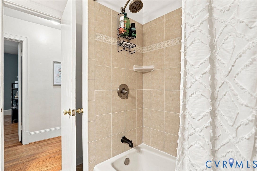 1427 Spring Grove Drive, Richmond, VA 23225 Shower with neutral-toned wall tiling and a rainfall showerhead