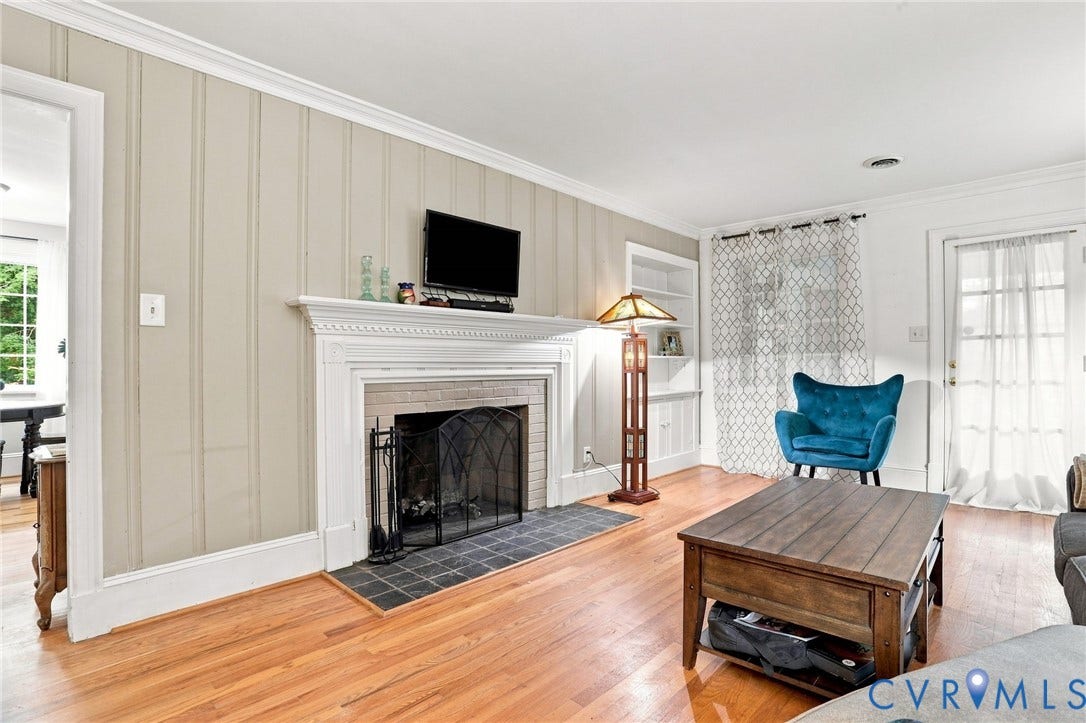 1427 Spring Grove Drive, Richmond, VA 23225 Hardwood flooring, crown molding, fireplace with mantel and tile surround, built-in shelving, and a door with glass panels