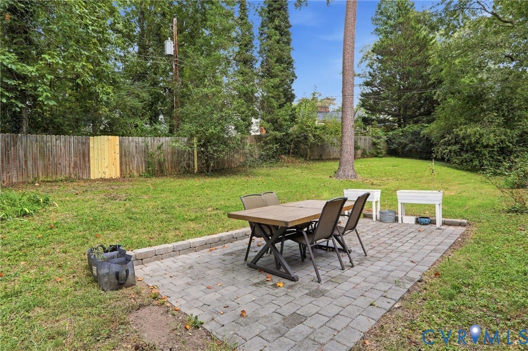 1427 Spring Grove Drive, Richmond, VA 23225 Paver patio with a stone block border and a wooden privacy fence