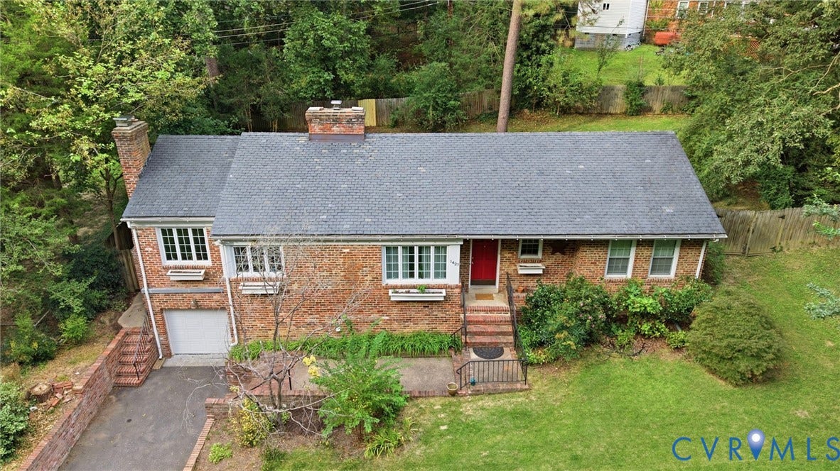 1427 Spring Grove Drive, Richmond, VA 23225 Brick exterior with a dark shingle roof and white window trim