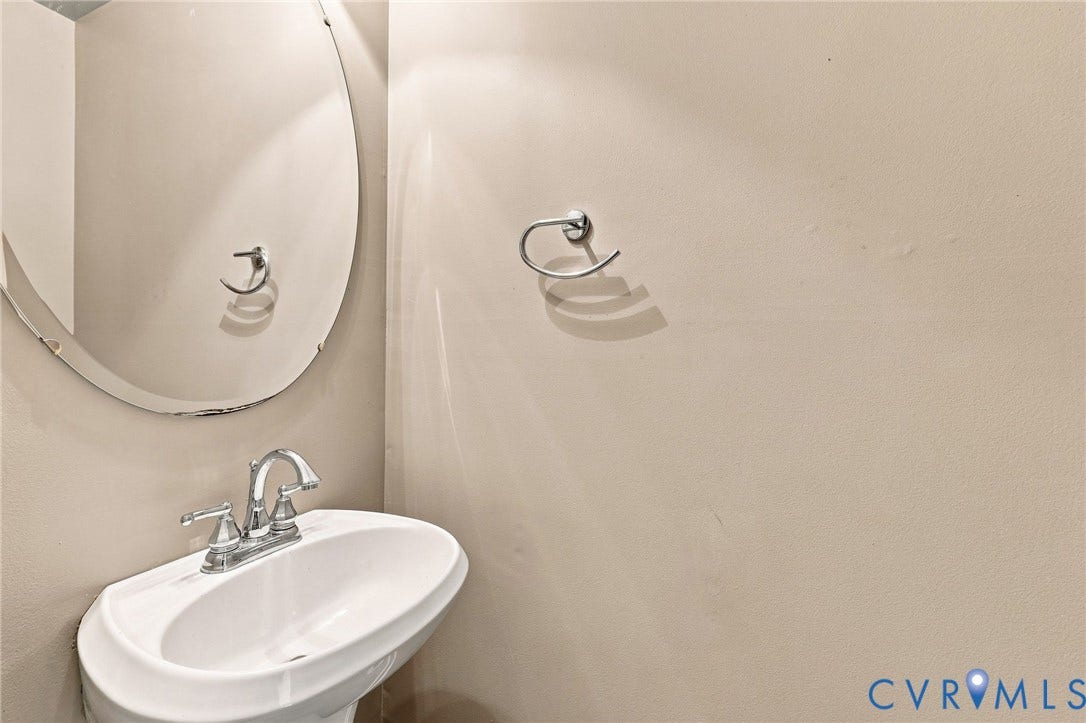 3522 Fairfield Road, Powhatan, VA 23139 Pedestal sink with chrome-finish faucet and oval wall mirror