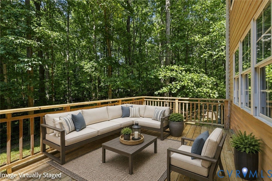 3522 Fairfield Road, Powhatan, VA 23139 Virtual Staged Expansive wood deck with a natural wood railing, surrounded by mature trees