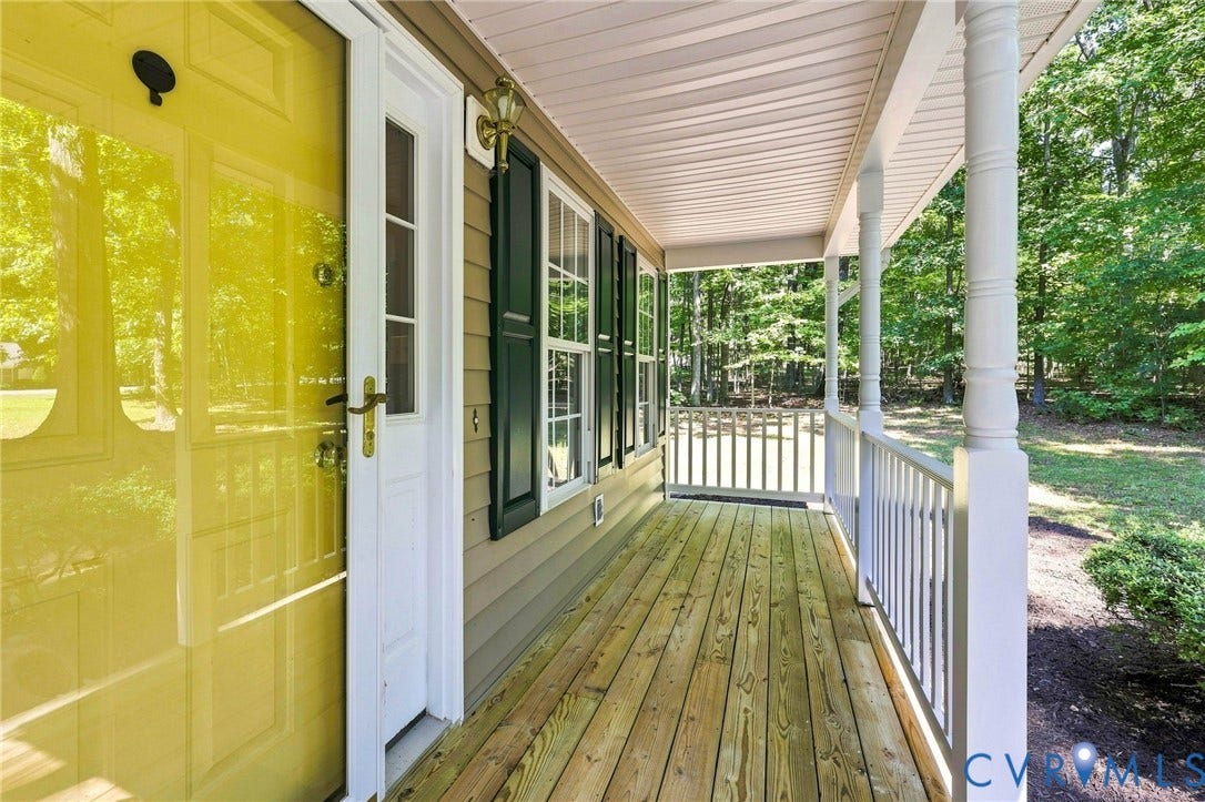 3522 Fairfield Road, Powhatan, VA 23139 Covered porch featuring wood-finish decking, white railings, and decorative columns
