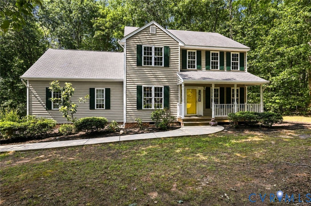 3522 Fairfield Road, Powhatan, VA 23139 Two-story residence featuring light-colored siding, a covered porch with white railings, a yellow front door, and dark green window shutters