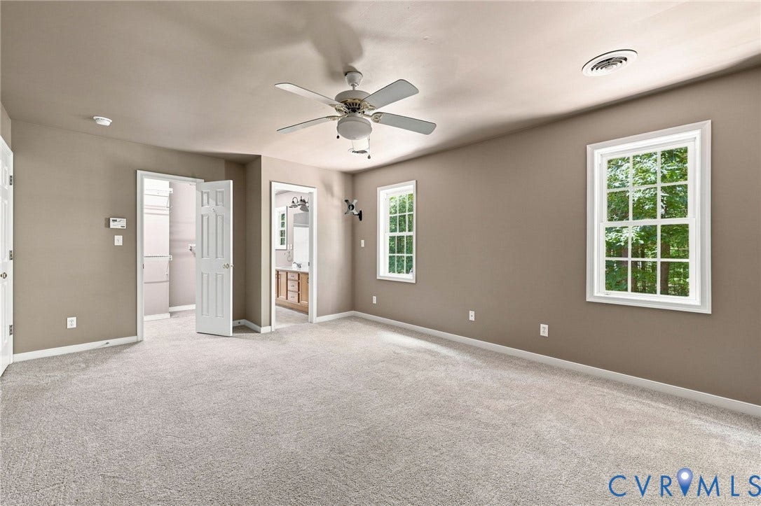 3522 Fairfield Road, Powhatan, VA 23139 Carpeted room with a ceiling fan, two windows, and multiple doorways