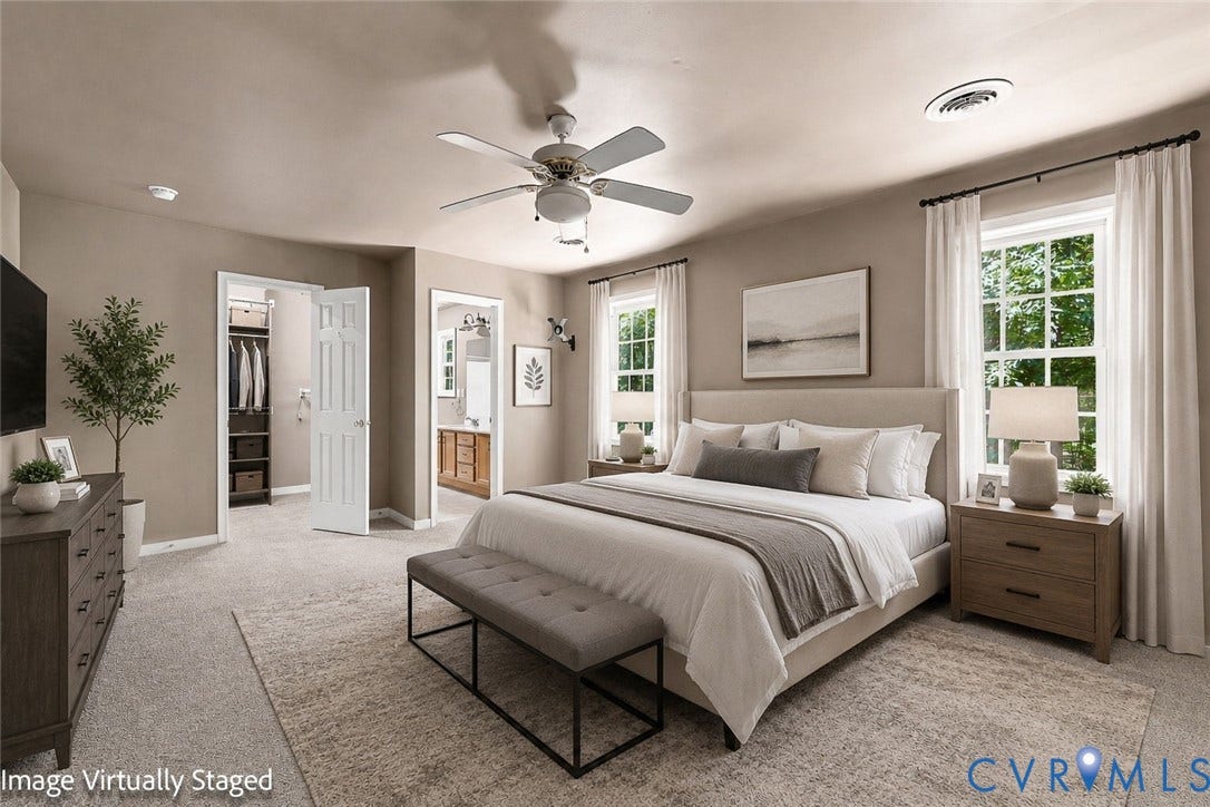 3522 Fairfield Road, Powhatan, VA 23139 Virtual Staged Bedroom Carpeted flooring, ceiling fan, two windows with white curtains, a built-in closet with shelving, and a bathroom with a dual vanity