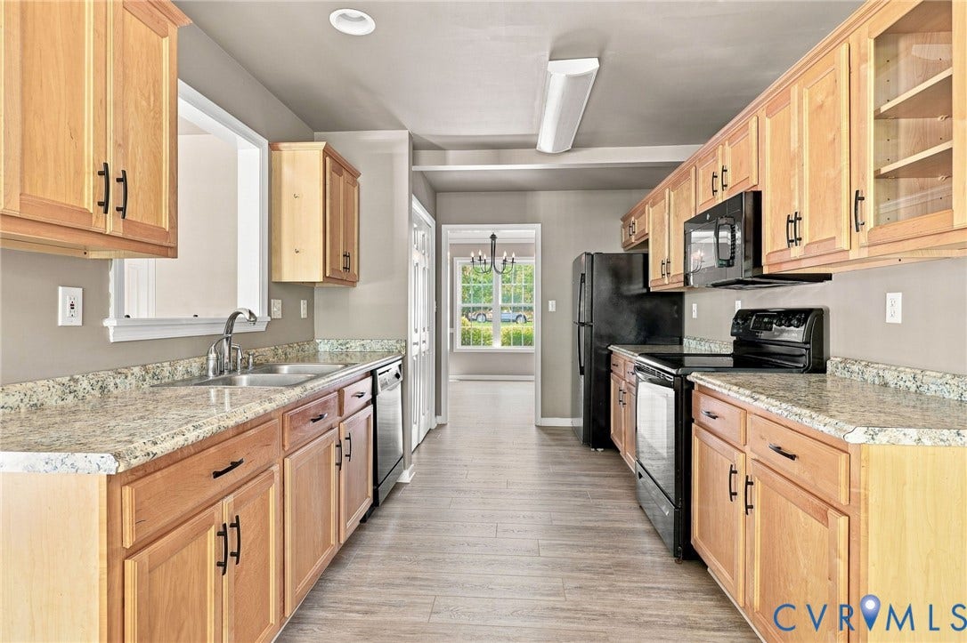 3522 Fairfield Road, Powhatan, VA 23139 Kitchen featuring wood-finish cabinetry, light-toned countertops, black appliances, and wood-finish flooring
