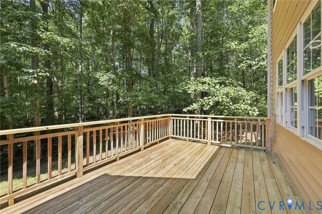 3522 Fairfield Road, Powhatan, VA 23139 Spacious wood deck with natural wood railing, ample natural light, and a backdrop of mature trees
