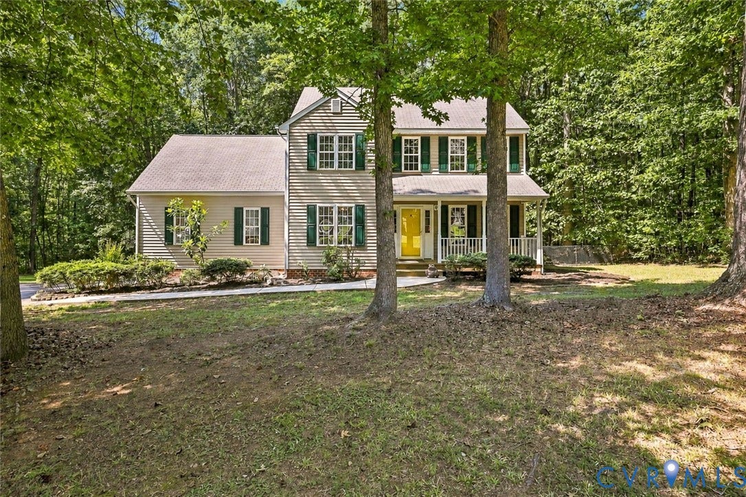 3522 Fairfield Road, Powhatan, VA 23139 Two-story exterior with light-toned siding, a covered front porch, and a bright yellow front door