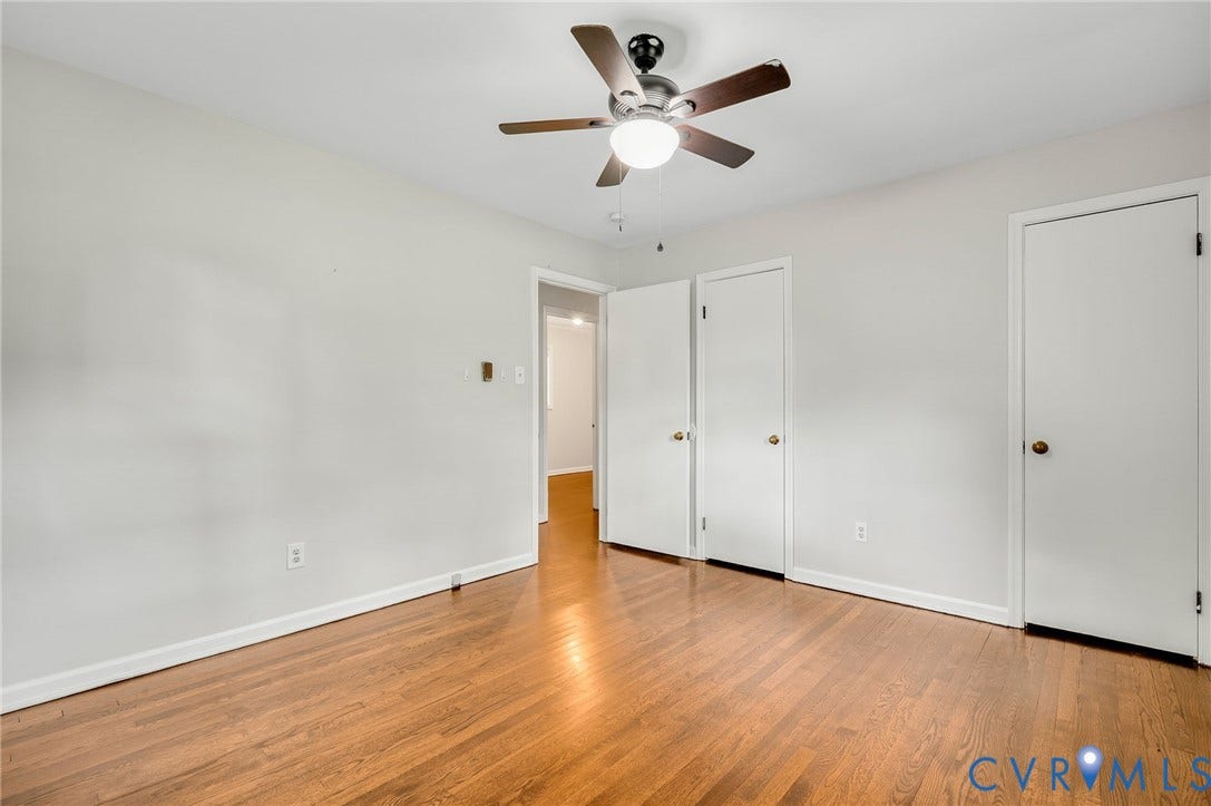 5322 Germain Road, Piney Knolls, Richmond, VA 23224 Wood-finish flooring, two white doors, white walls, and a ceiling fan with integrated lighting