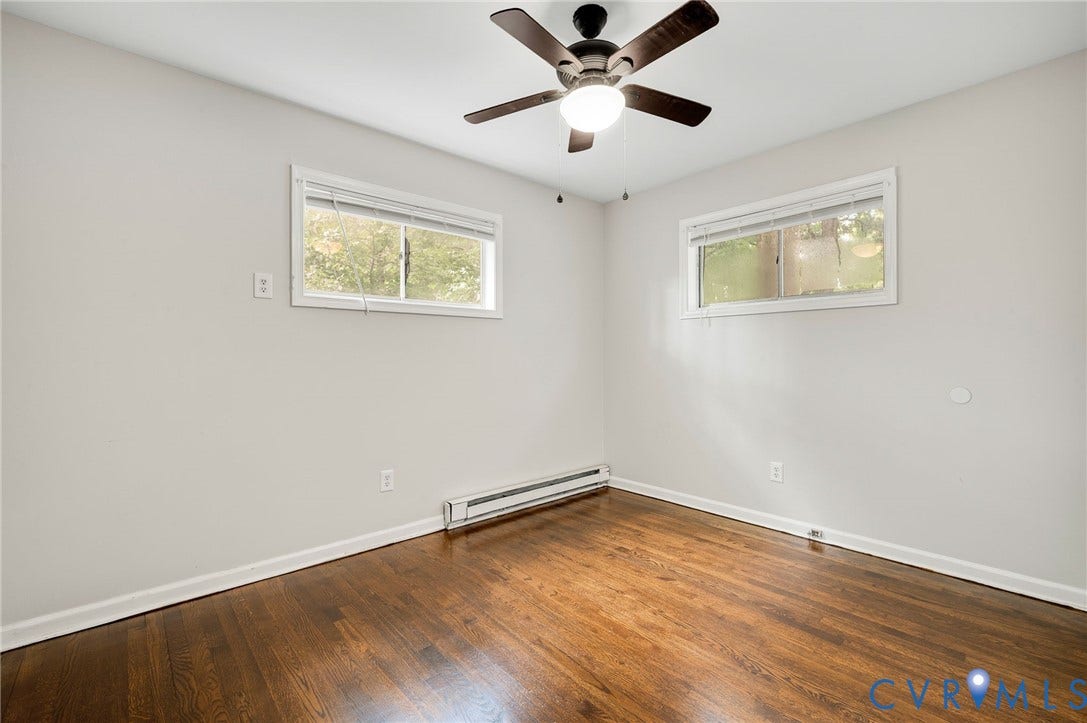 5322 Germain Road, Piney Knolls, Richmond, VA 23224 Wood-finish flooring, white walls, two windows, and a ceiling fan with integrated lighting