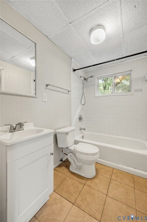 5322 Germain Road, Piney Knolls, Richmond, VA 23224 White tile flooring, white vanity with integrated sink, white tiled shower, and a window