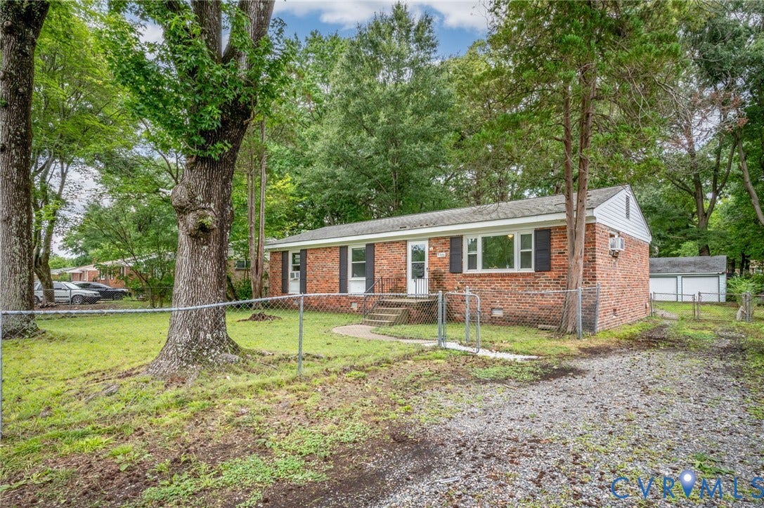 5322 Germain Road, Piney Knolls, Richmond, VA 23224 Brick exterior with white siding accents, front entry with storm door, and mature trees