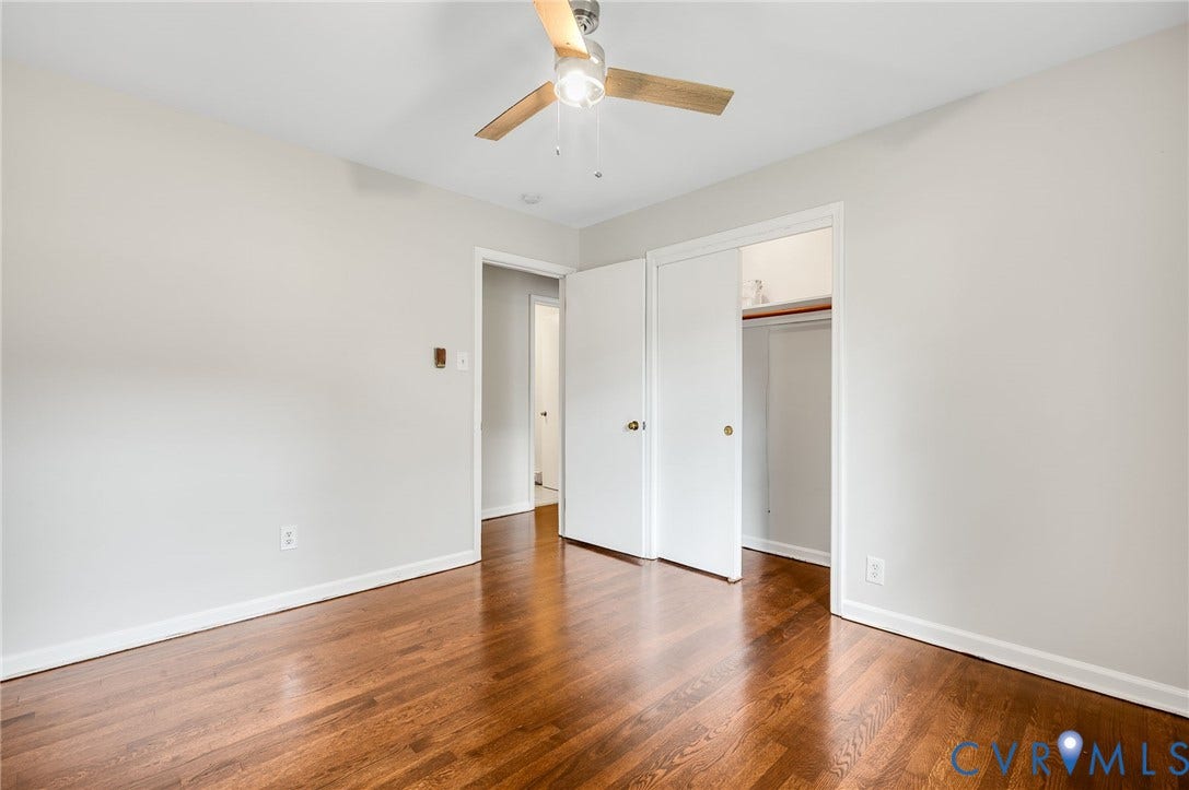 5322 Germain Road, Piney Knolls, Richmond, VA 23224 Hardwood flooring, light gray wall paint, white trim, ceiling fan, and sliding closet doors