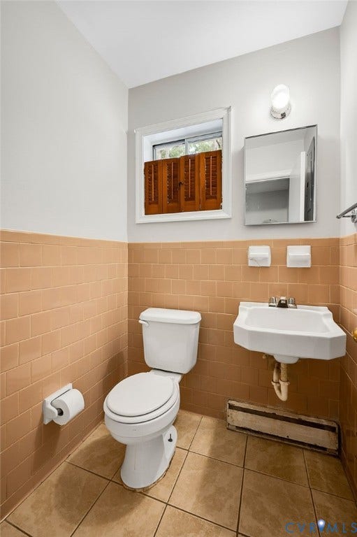 5322 Germain Road, Piney Knolls, Richmond, VA 23224 White wall-mounted sink, ceramic tile flooring, and a window with wood shutters