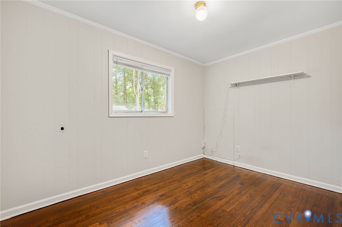 5322 Germain Road, Piney Knolls, Richmond, VA 23224 Hardwood flooring, painted paneled walls, white trim, and a window with blinds