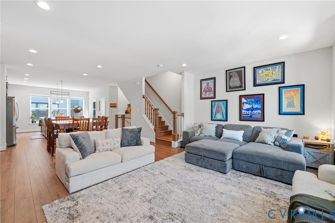Open-concept living space with recessed lighting, wood-finish flooring, and a dining area