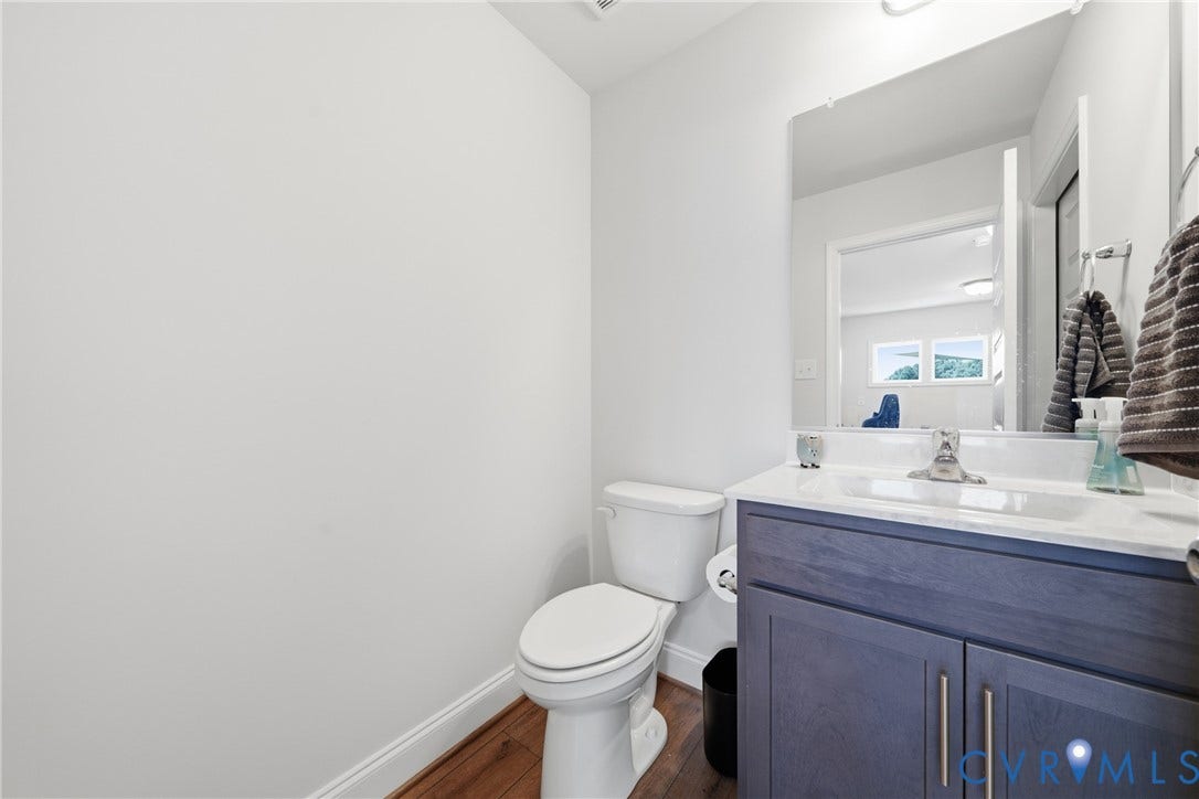 White vanity with dual cabinet doors, chrome faucet, and integrated sink