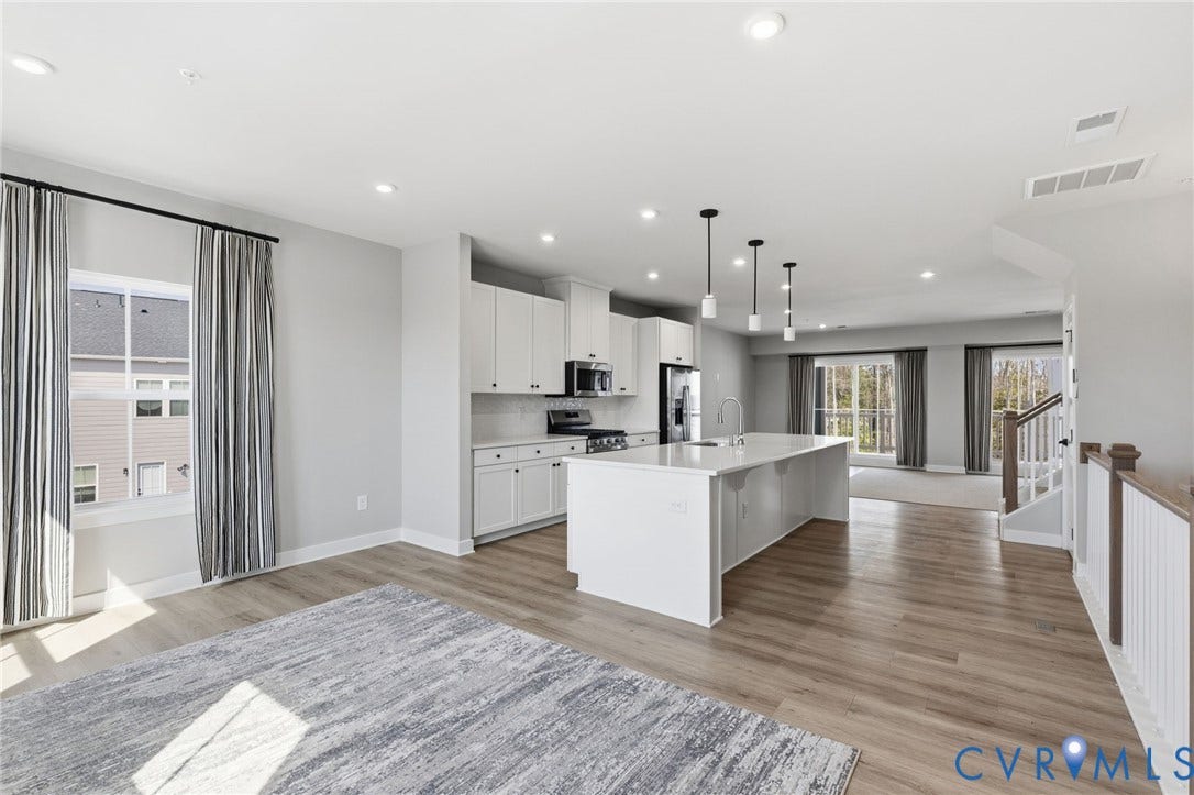Open-concept kitchen and living area with wood-finish flooring