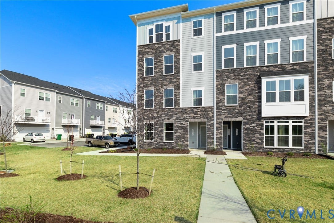 Multi-story facade featuring stone and siding elements