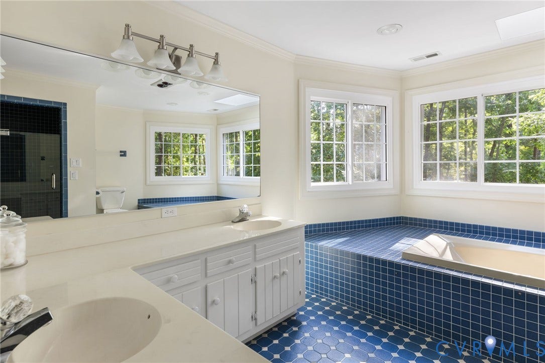 14411 Galloway Court, Salisbury, Midlothian, VA 23113 Dual vanity with integrated sinks, built-in soaking tub, blue tile flooring, tiled shower enclosure, and multiple windows