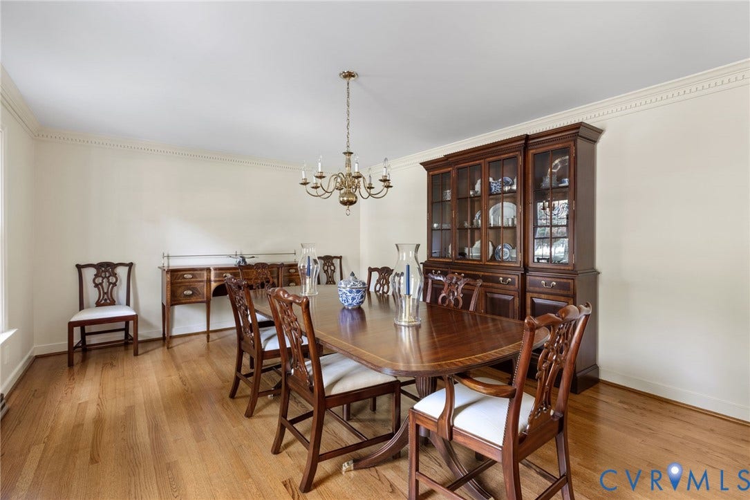 14411 Galloway Court, Salisbury, Midlothian, VA 23113 Hardwood flooring, crown molding, and a brass chandelier illuminate this dining space