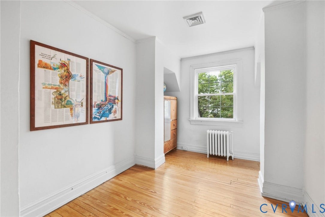 2415 Maplewood Avenue, Byrd Park, Richmond, VA 23220 Hardwood flooring, painted white walls, white window frame, white baseboard trim, and a white radiator