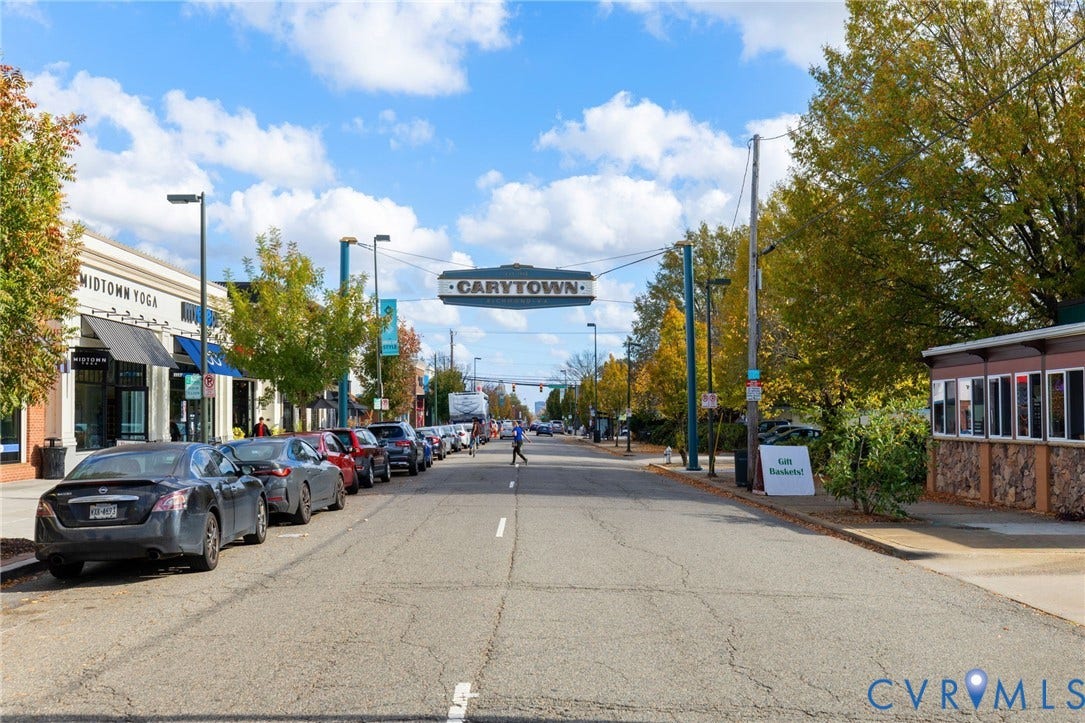 2415 Maplewood Avenue, Byrd Park, Richmond, VA 23220 Vibrant street scene featuring commercial storefronts, mature street trees with autumn foliage, and a prominent "CARYTOWN" street sign