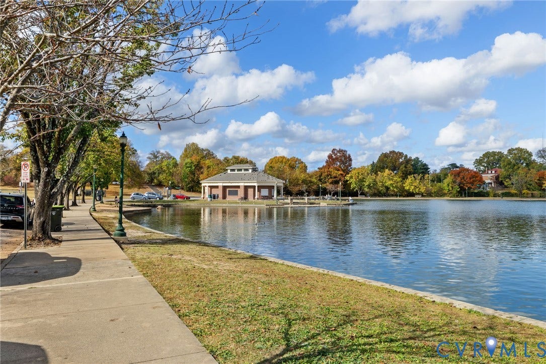 2415 Maplewood Avenue, Byrd Park, Richmond, VA 23220 Lakeside property featuring a paved walkway, mature trees, and a distant pavilion