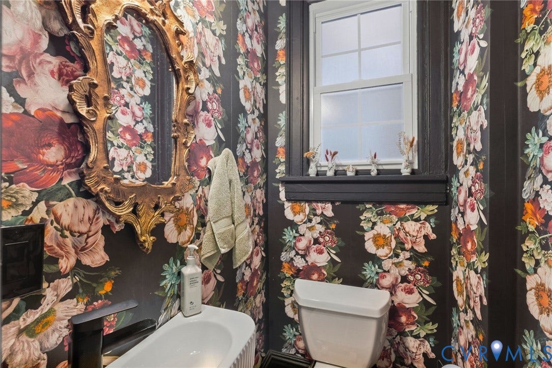 2415 Maplewood Avenue, Byrd Park, Richmond, VA 23220 Decorative wallpaper, ornate gold-tone framed mirror, white single-hung window, dark window trim, and white toilet