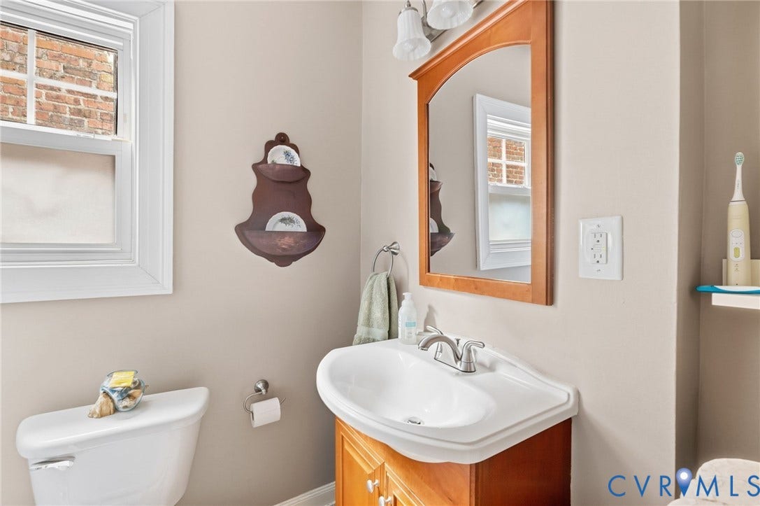 2415 Maplewood Avenue, Byrd Park, Richmond, VA 23220 Integrated vanity with a white ceramic sink, chrome-finish faucet, and wood-finish cabinetry