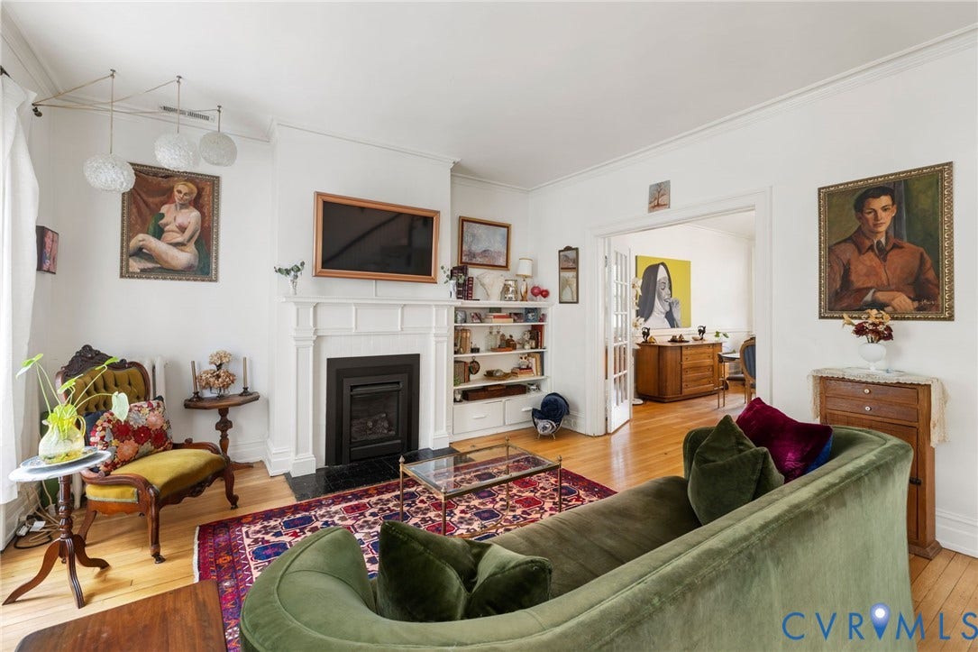 2415 Maplewood Avenue, Byrd Park, Richmond, VA 23220 Hardwood flooring throughout, white crown molding, a built-in fireplace with a stone hearth, and integrated shelving