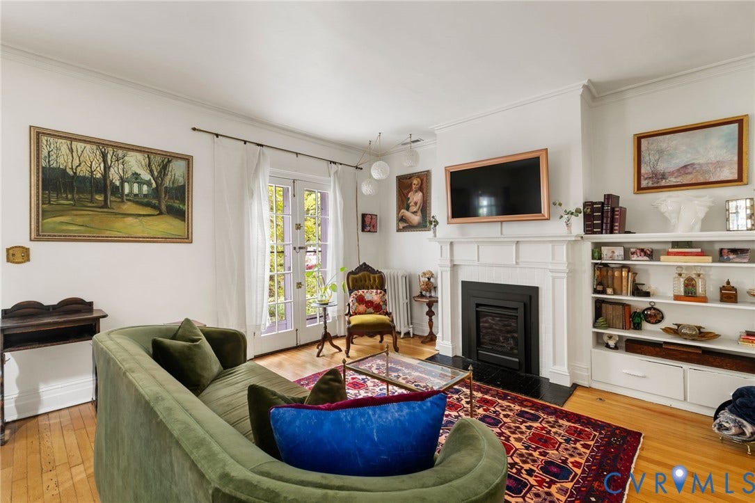 2415 Maplewood Avenue, Byrd Park, Richmond, VA 23220 Hardwood flooring, white crown molding, built-in shelving, white double doors, and a decorative fireplace with a mantel