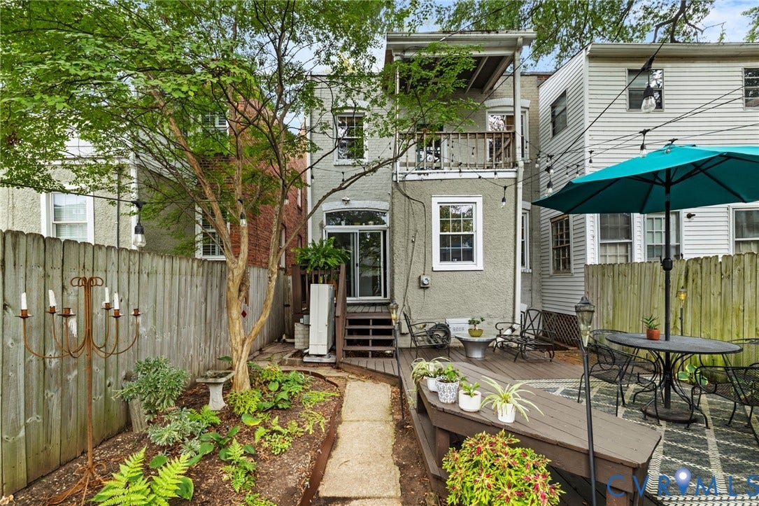 2415 Maplewood Avenue, Byrd Park, Richmond, VA 23220 Backyard featuring a privacy fence, multi-level decking, sliding glass door access, and a second-story balcony
