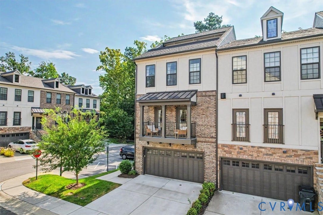 1141 Broad Hill Trace, Saunders Station Townes, Henrico, VA 23233 Contemporary townhome with a brick and stucco exterior, featuring a private balcony, two-car garage, and dormer window
