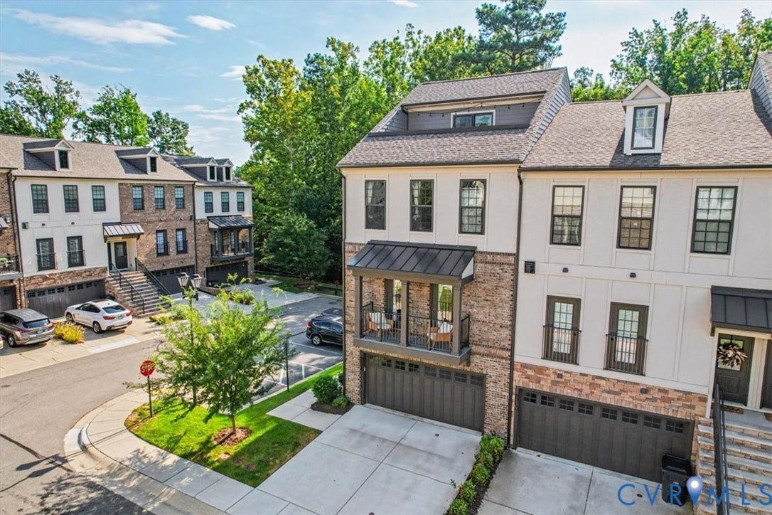 1141 Broad Hill Trace, Saunders Station Townes, Henrico, VA 23233 Multi-level townhome with brick and stucco exterior, prominent dormer windows, and a covered balcony