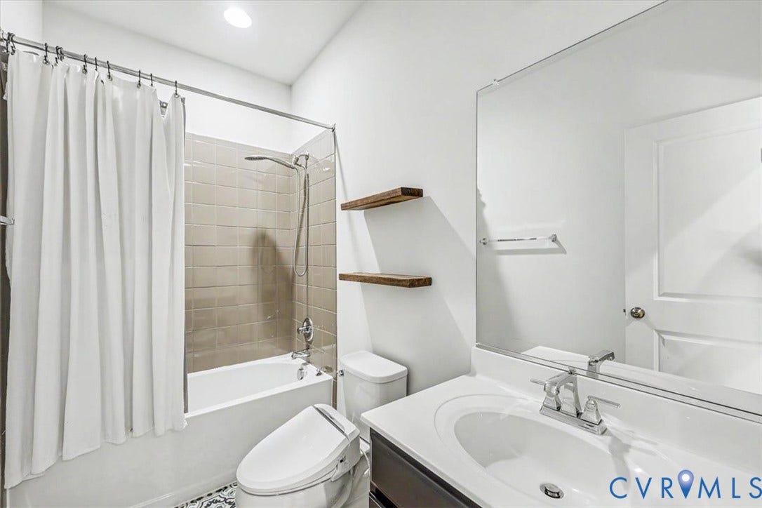 1141 Broad Hill Trace, Saunders Station Townes, Henrico, VA 23233 Bathroom featuring a built-in tub with subway tile surround, floating wood shelves, and a vanity with an integrated sink