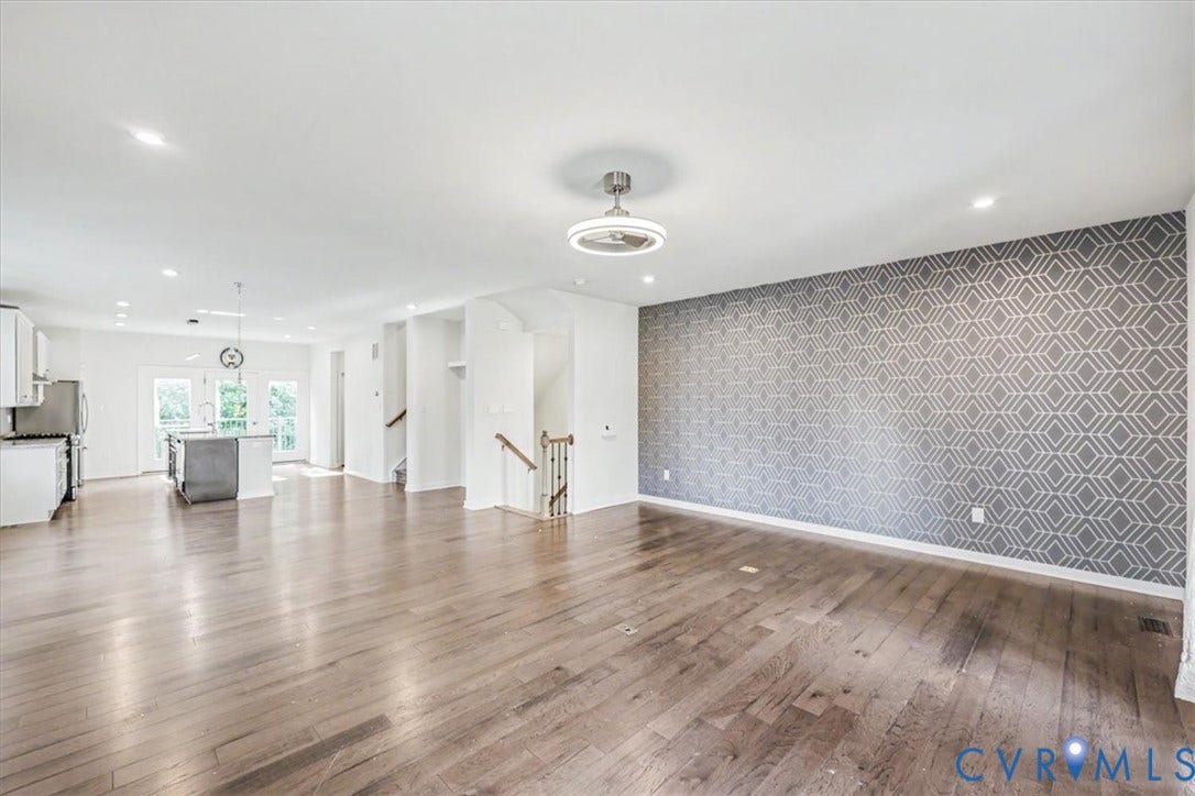 1141 Broad Hill Trace, Saunders Station Townes, Henrico, VA 23233 Expansive room with wood-finish flooring, recessed lighting, and a decorative accent wall