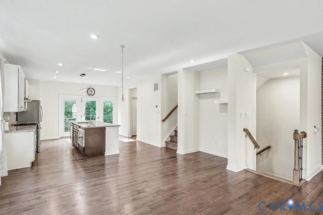 1141 Broad Hill Trace, Saunders Station Townes, Henrico, VA 23233 Open-concept living area with dark wood-finish flooring, recessed lighting, and a kitchen island with a stone countertop