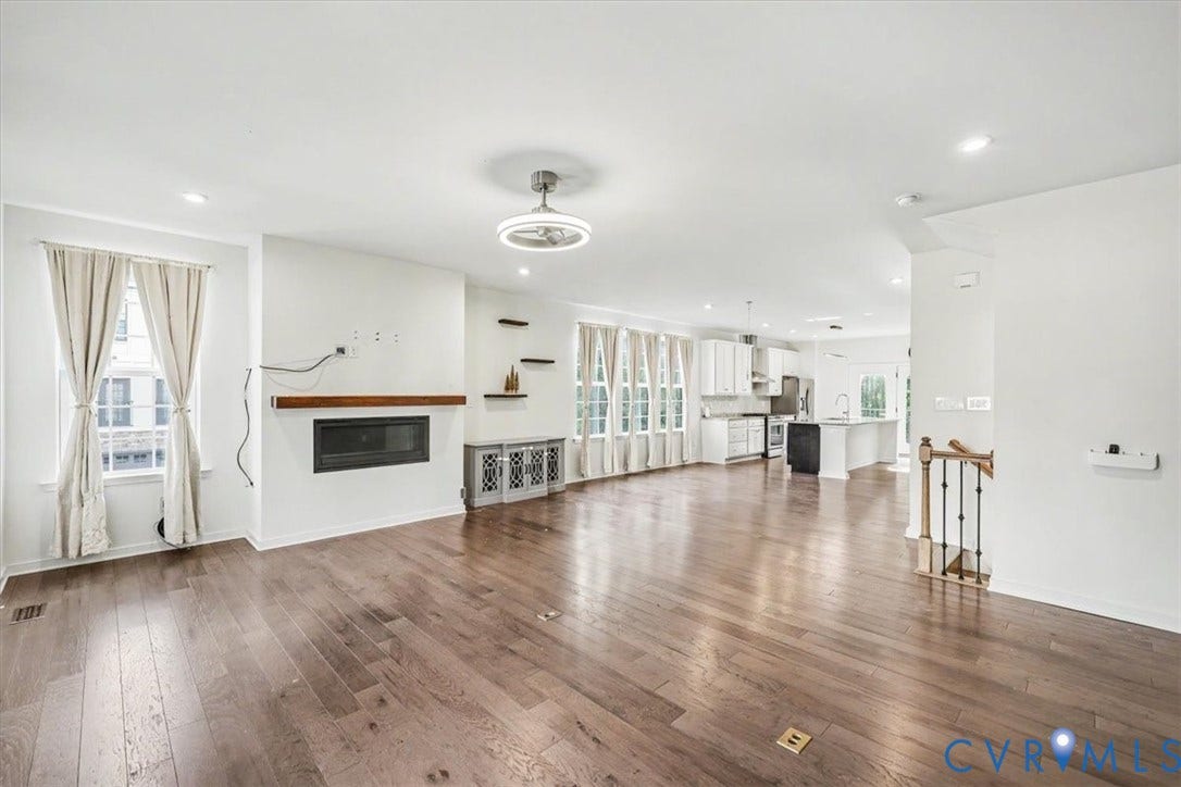 1141 Broad Hill Trace, Saunders Station Townes, Henrico, VA 23233 Spacious room featuring wood-finish flooring, a built-in fireplace with a wood mantle, recessed lighting, and a modern ceiling fan
