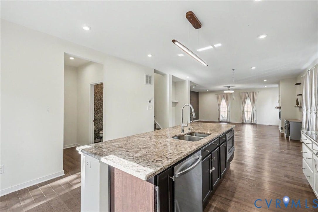 1141 Broad Hill Trace, Saunders Station Townes, Henrico, VA 23233 Kitchen island with a light-toned countertop, stainless steel sink, and integrated dishwasher