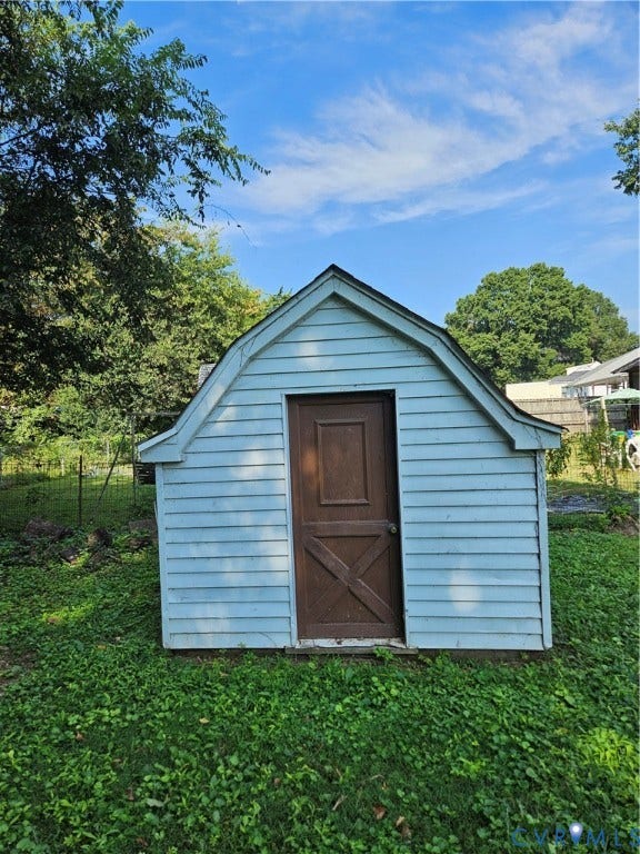 Light blue siding on the exterior structure with a gambrel roof