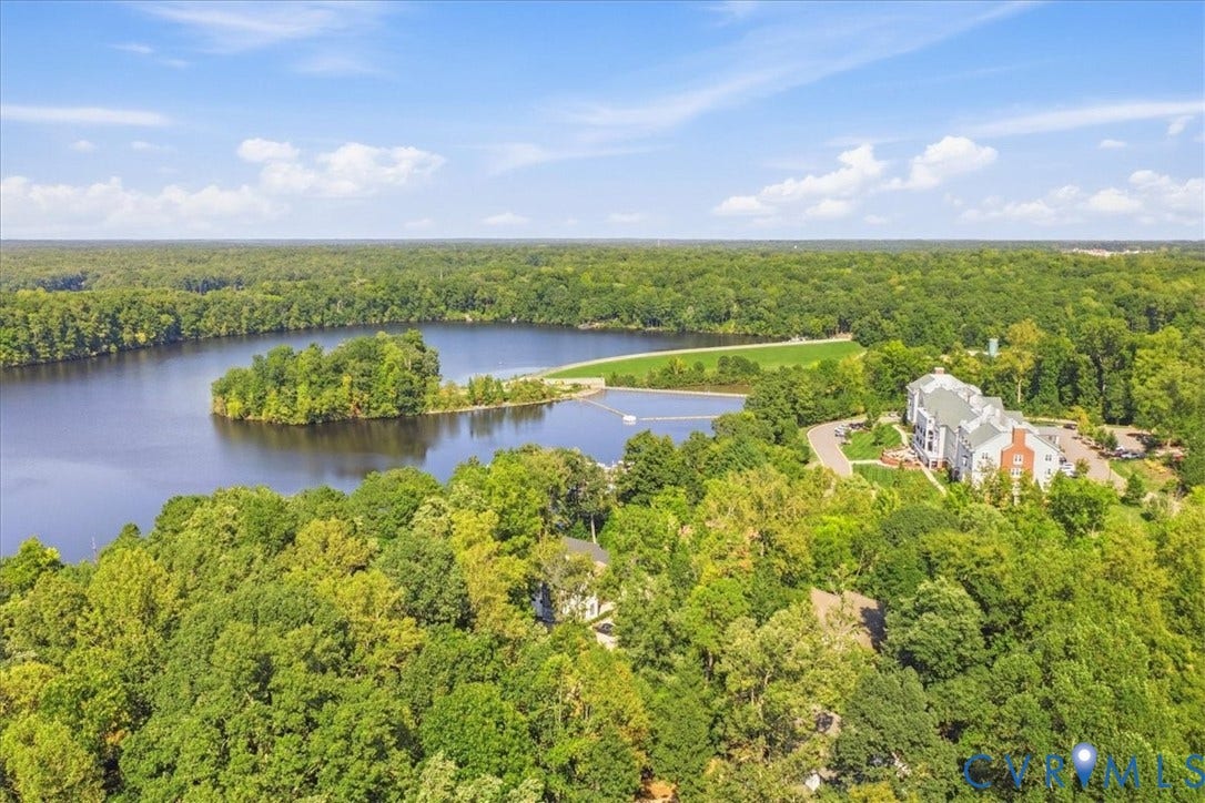 Extensive natural landscape with abundant mature trees and a substantial body of water