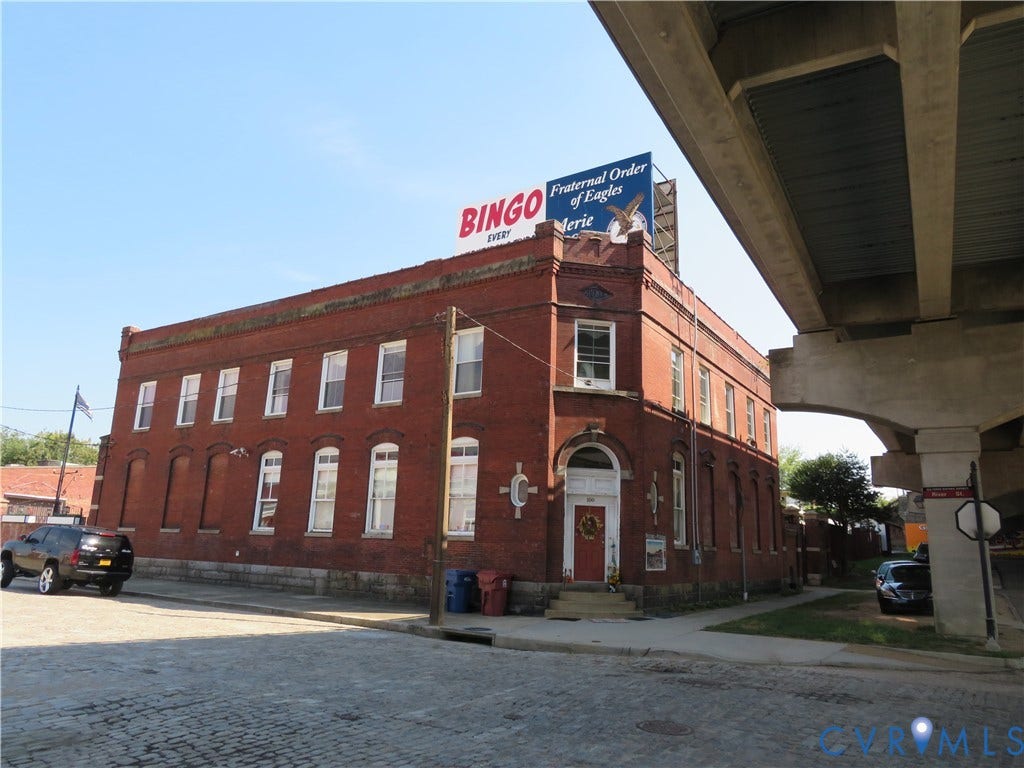 136 River Street, Petersburg, VA 23803 Brick building with a corner entrance, arched window detailing, and multiple windows