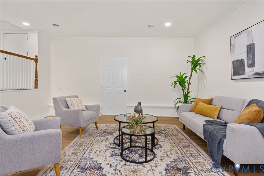 Recessed ceiling lighting, crown molding, wood-finish flooring, white paneled doors, and a wood handrail