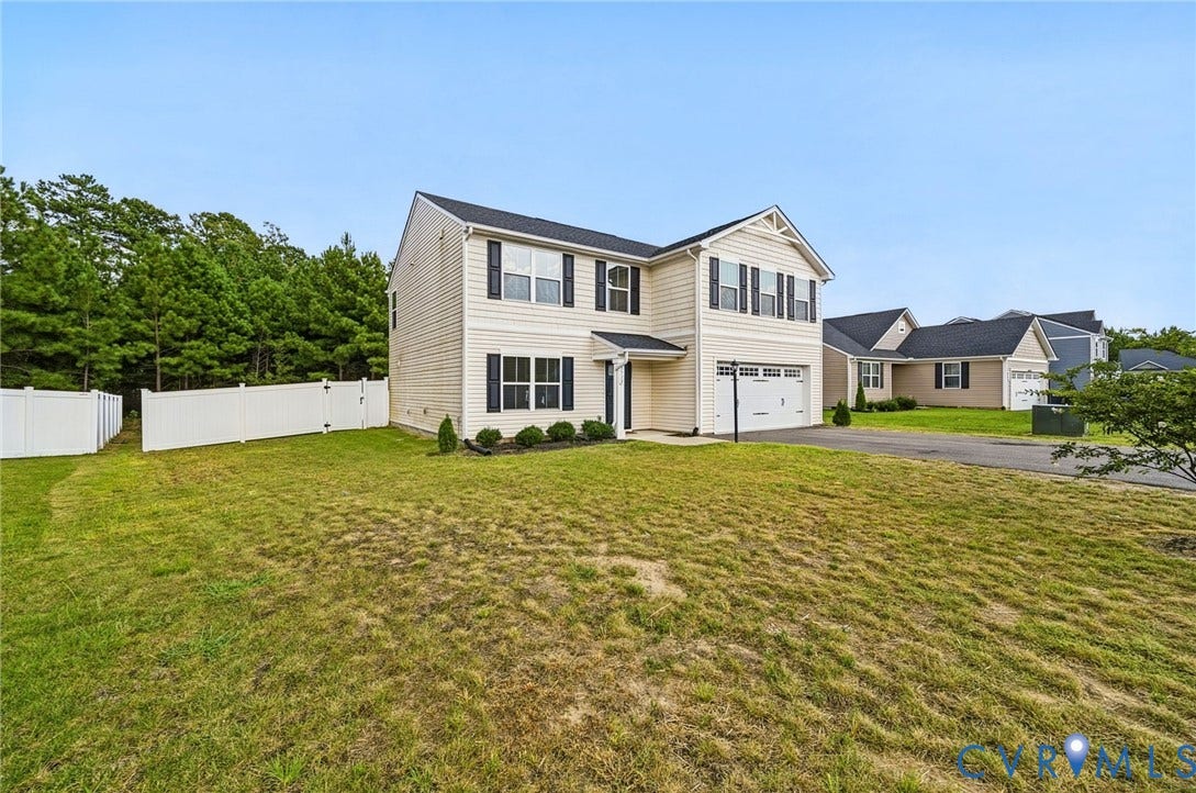 5713 Bison Ford Court, Chesterfield, VA 23234 Two-story residence featuring light-toned siding, dark shutters, and an attached two-car garage