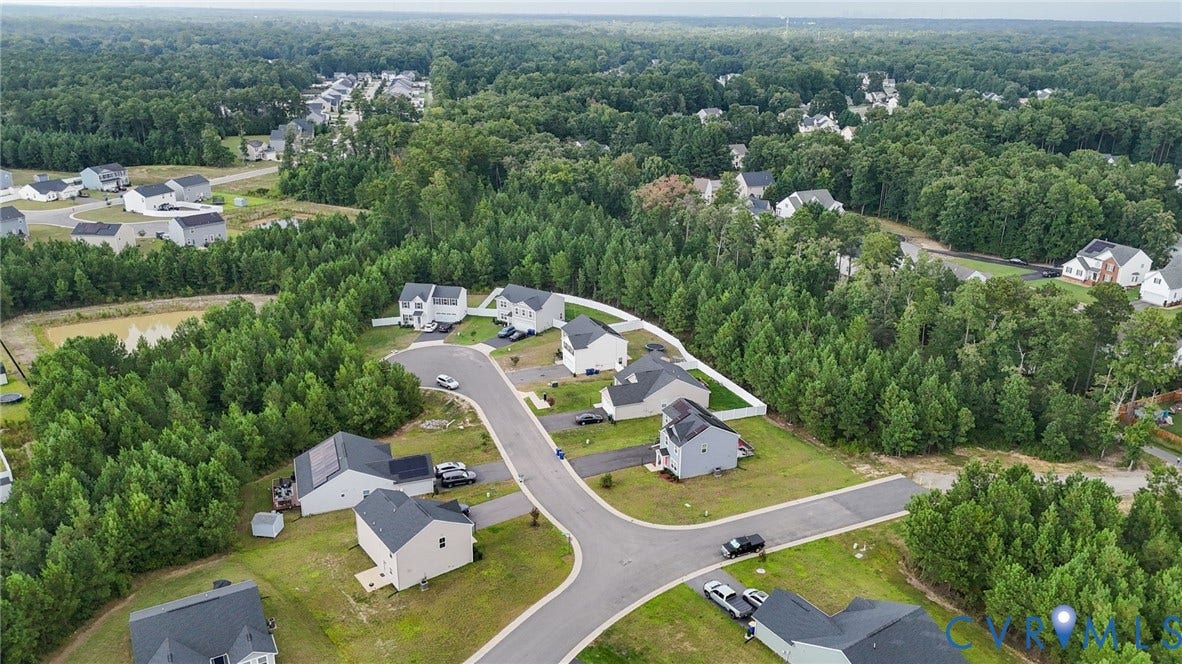 5713 Bison Ford Court, Chesterfield, VA 23234 Aerial perspective of a developed residential community with paved streets, surrounded by extensive mature tree coverage
