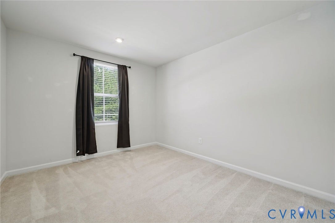 5713 Bison Ford Court, Chesterfield, VA 23234 Recessed lighting illuminates neutral-toned walls and plush carpeting, complemented by a window with blinds